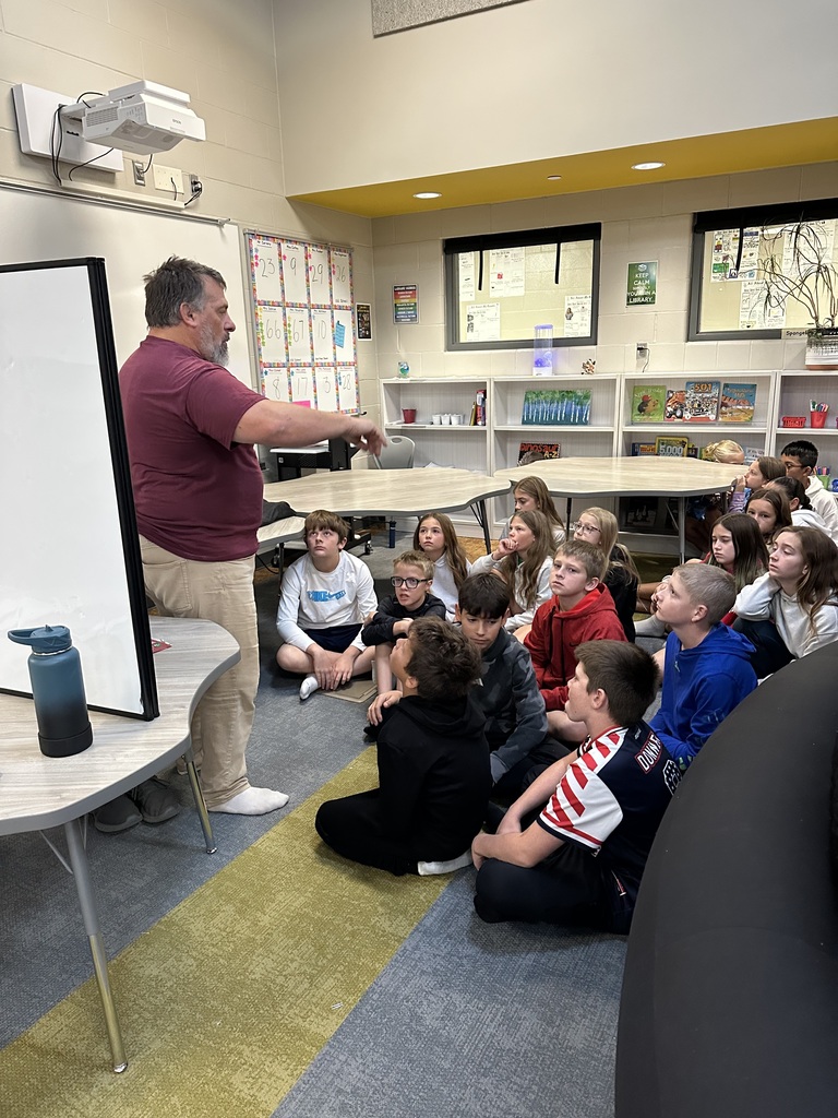 Students listening to a presentation at Harvest Hills Elementary about the planetarium.