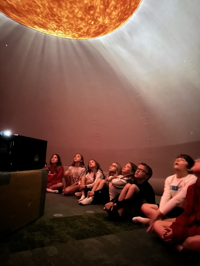 Students seated inside the planetarium in the Harvest Hills Media Center.