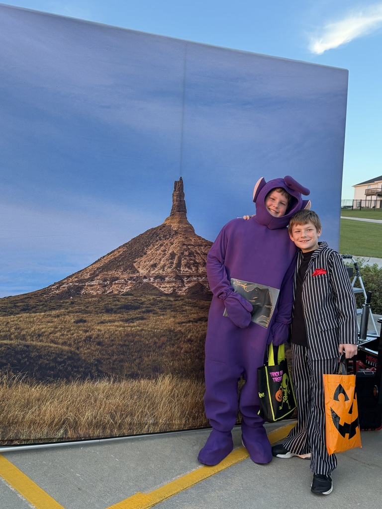 Students posing for a photo at the Harvest Hills Trunk or Treat Event.