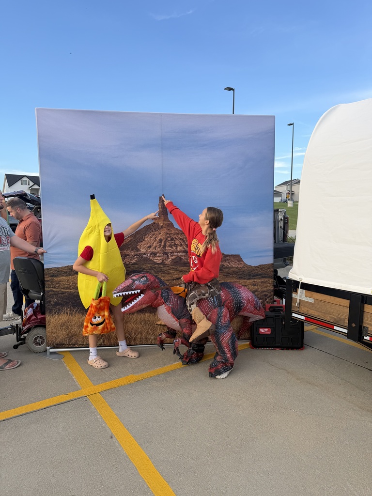 Students posing for a photo at the Harvest Hills Trunk or Treat Event.