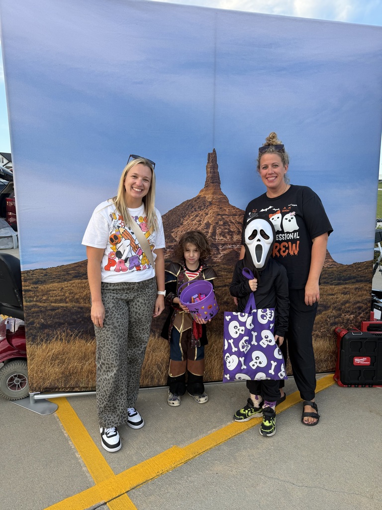 Kids and parents posing for a photo at the Harvest Hills Trunk or Treat Event.