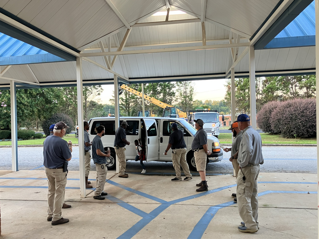 day care van at bus ramp with men greeting