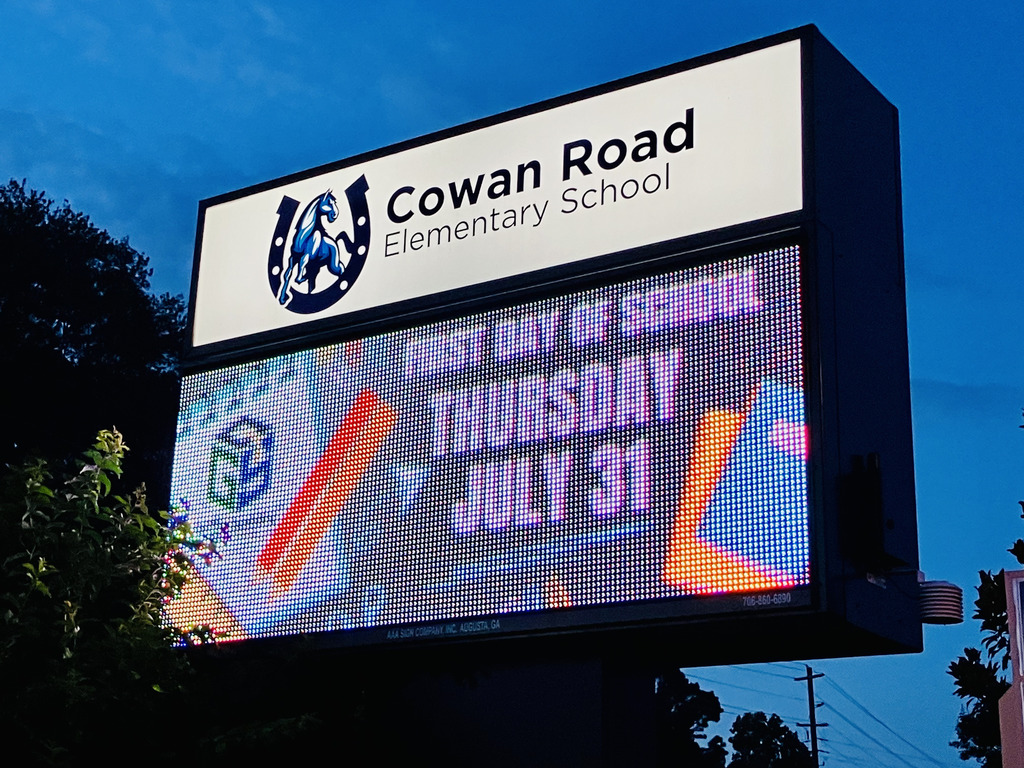 School sign reading "First day of school, Thursday, July 31"