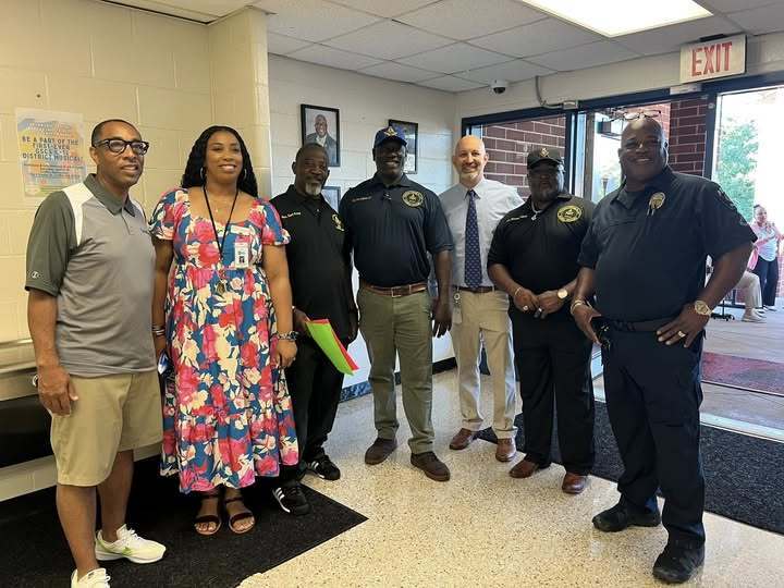 volunteers greeting students