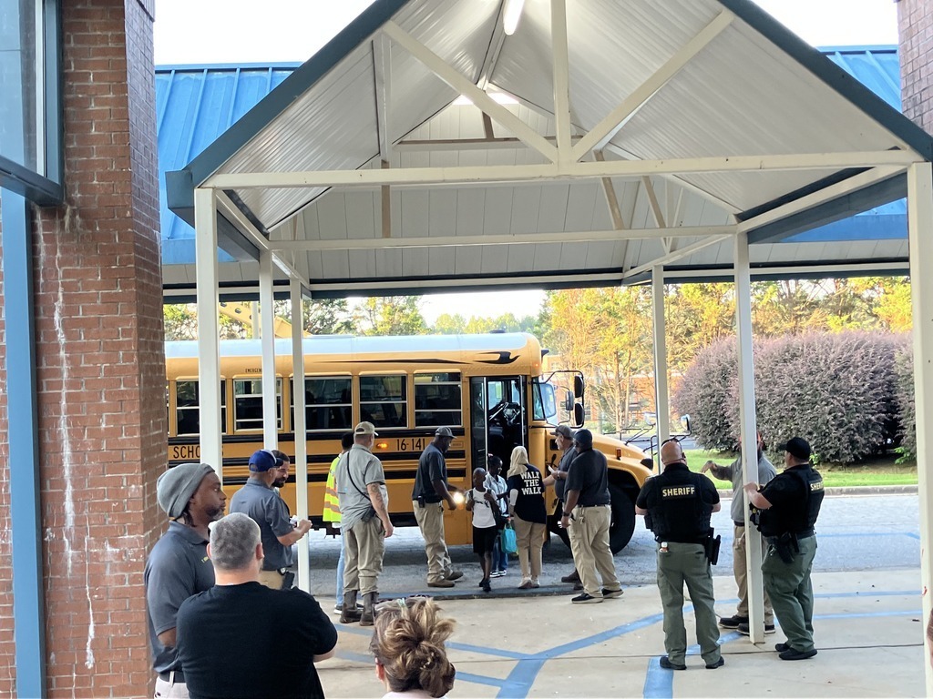 volunteers greeting students