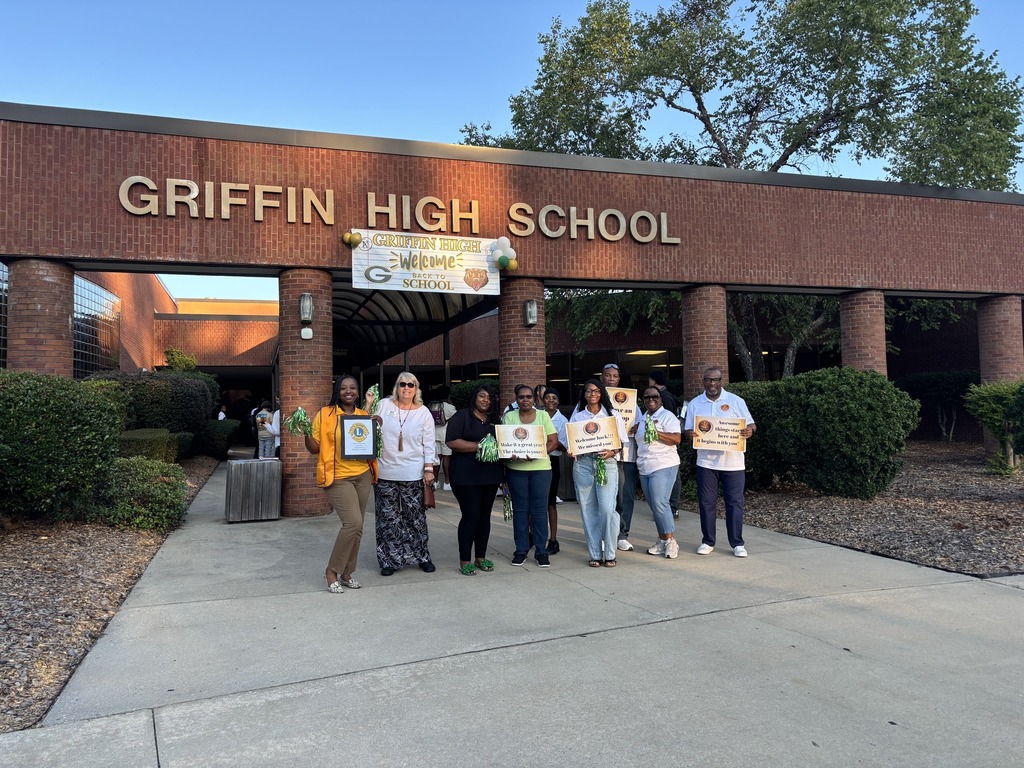 volunteers greeting students