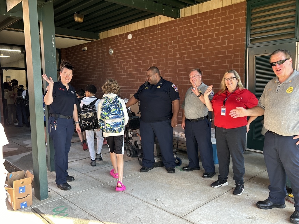 volunteers greeting students