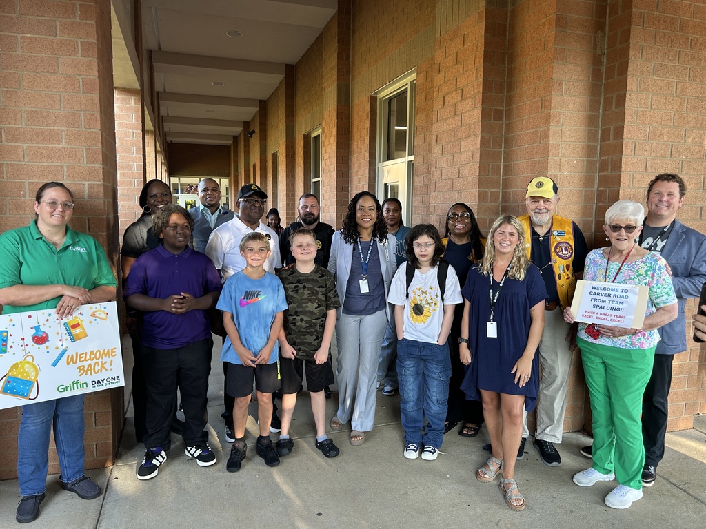 volunteers greeting students
