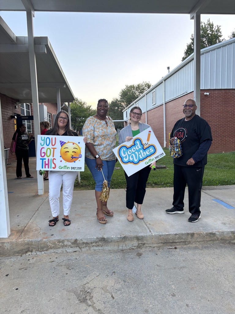 volunteers greeting students