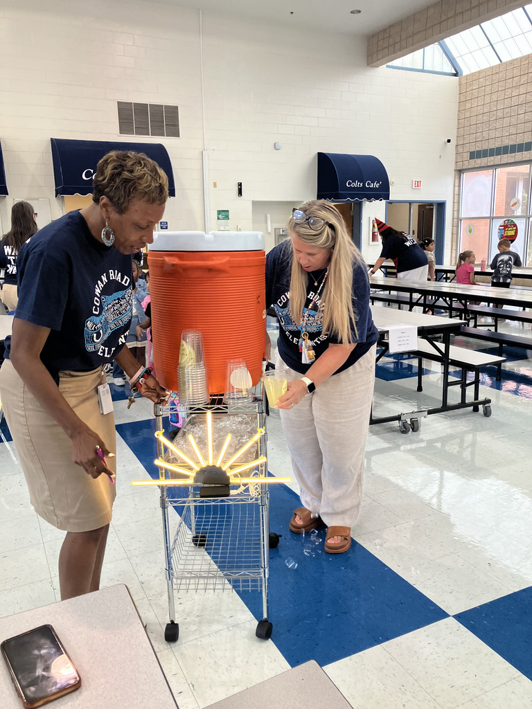 teachers with large container of lemonade