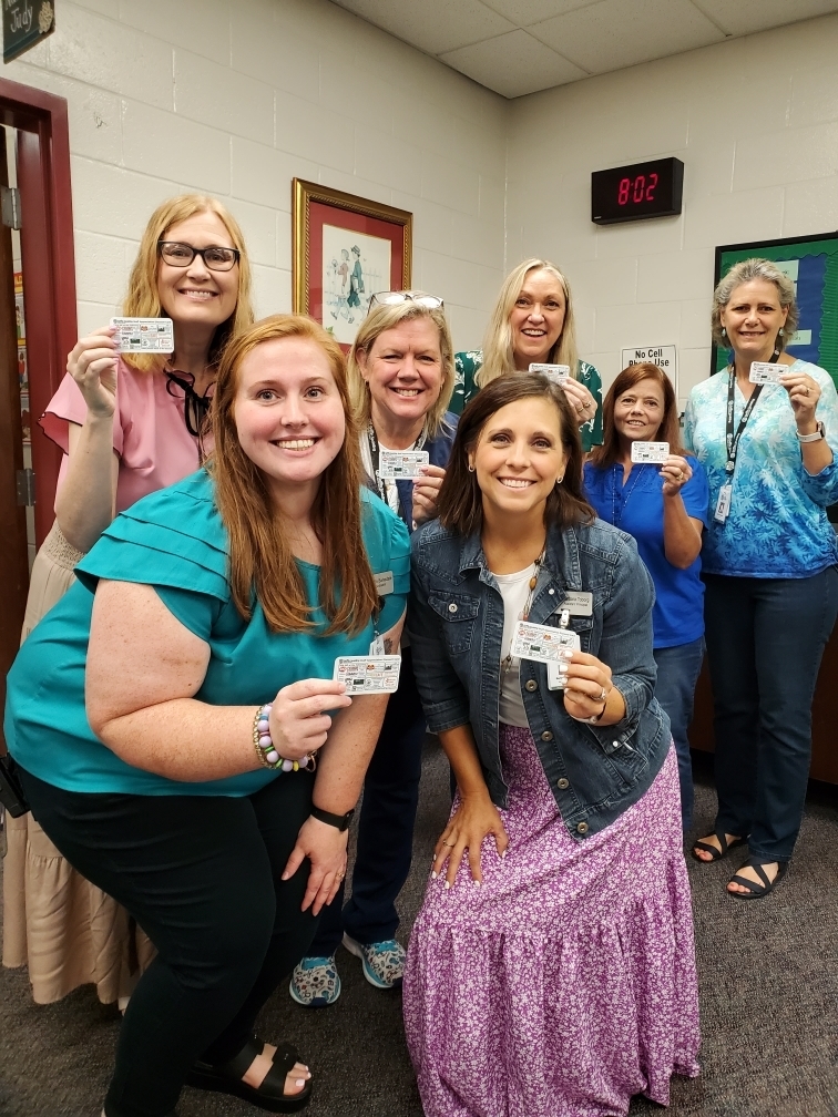 staff holding cards