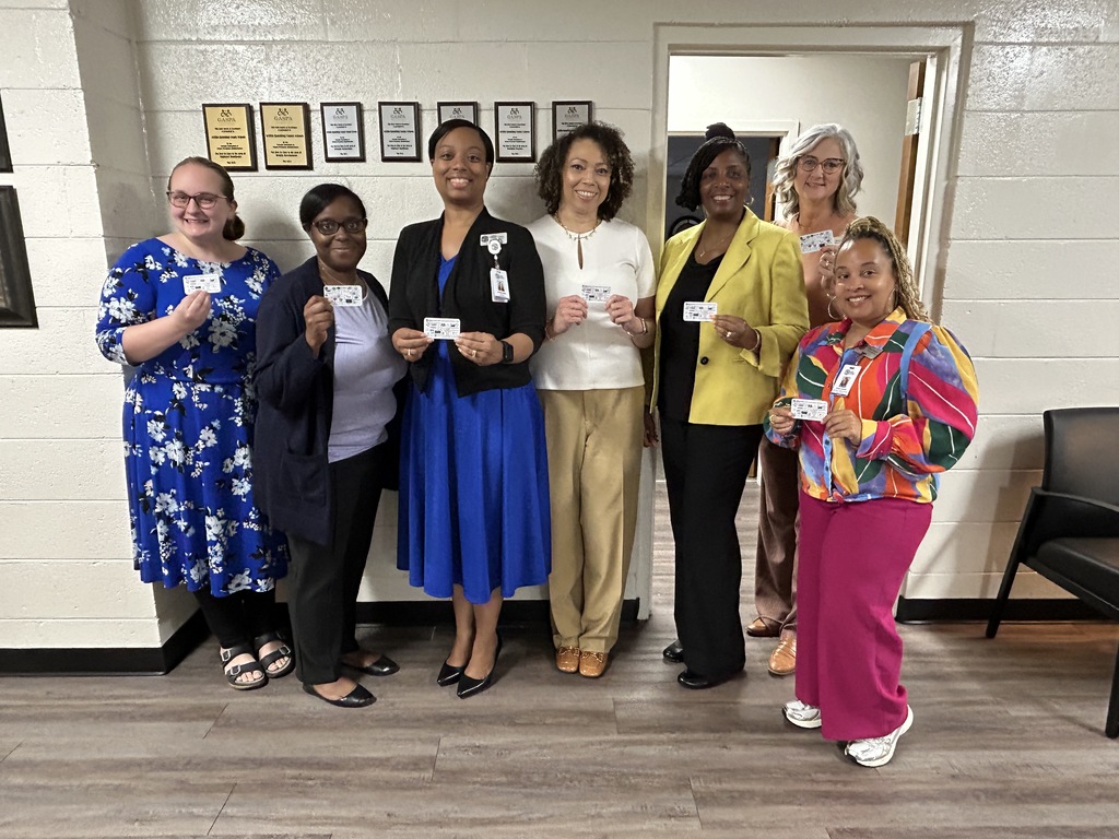 staff holding cards
