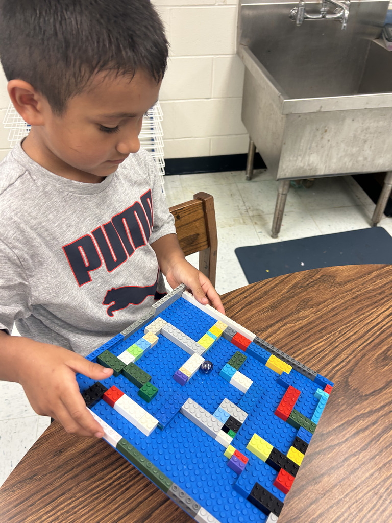 kids working with lego at tables, building mazes