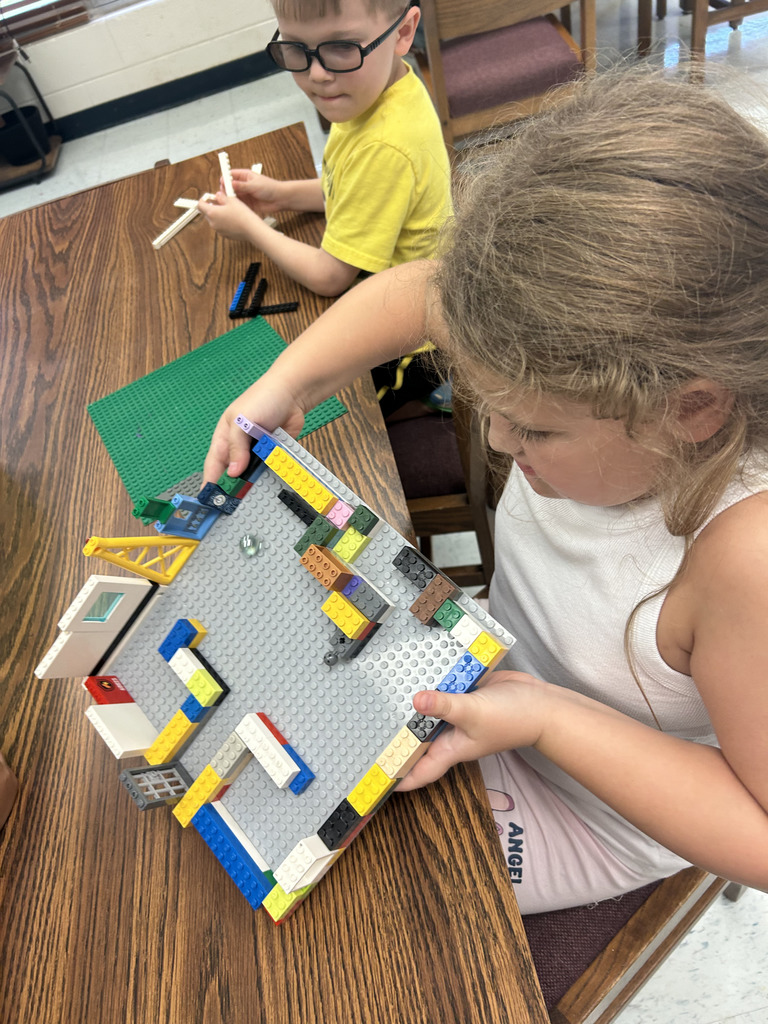 kids working with lego at tables, building mazes