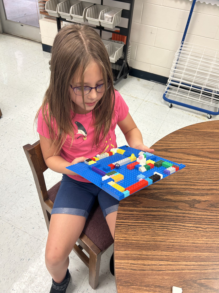kids working with lego at tables, building mazes