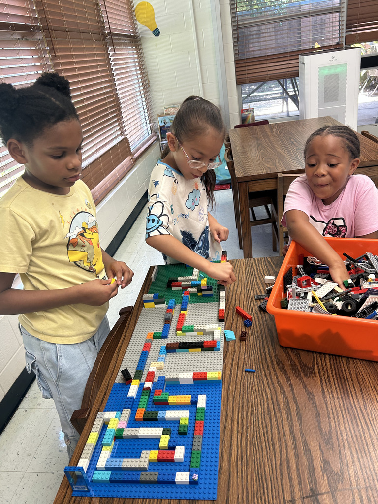 kids working with lego at tables, building mazes