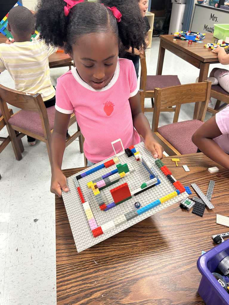 kids working with lego at tables, building mazes