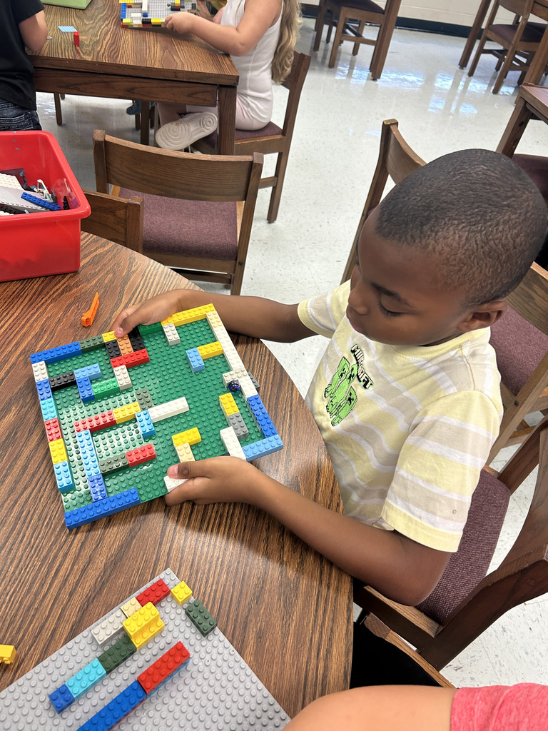 kids working with lego at tables, building mazes
