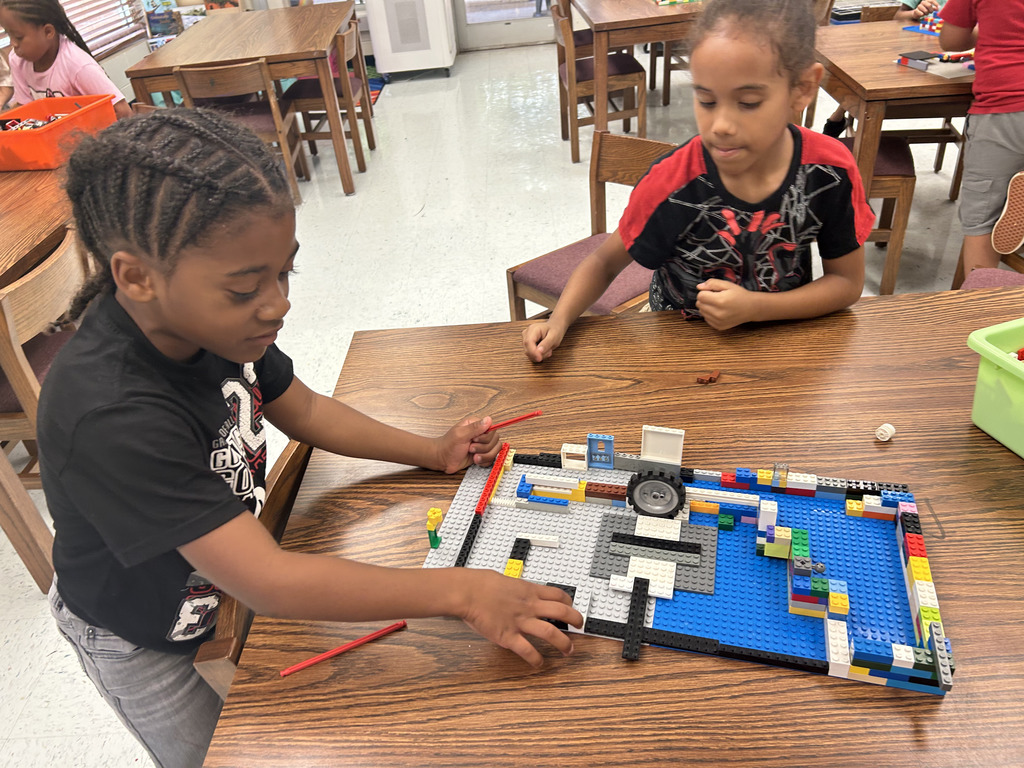 kids working with lego at tables, building mazes