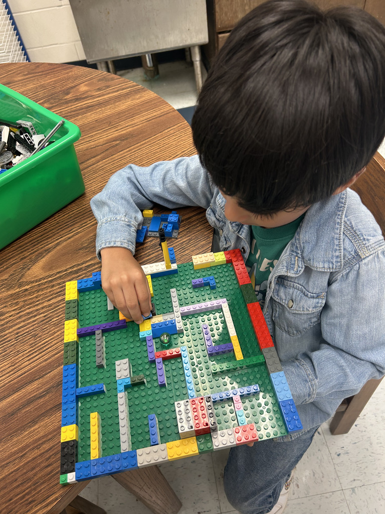 kids working with lego at tables, building mazes