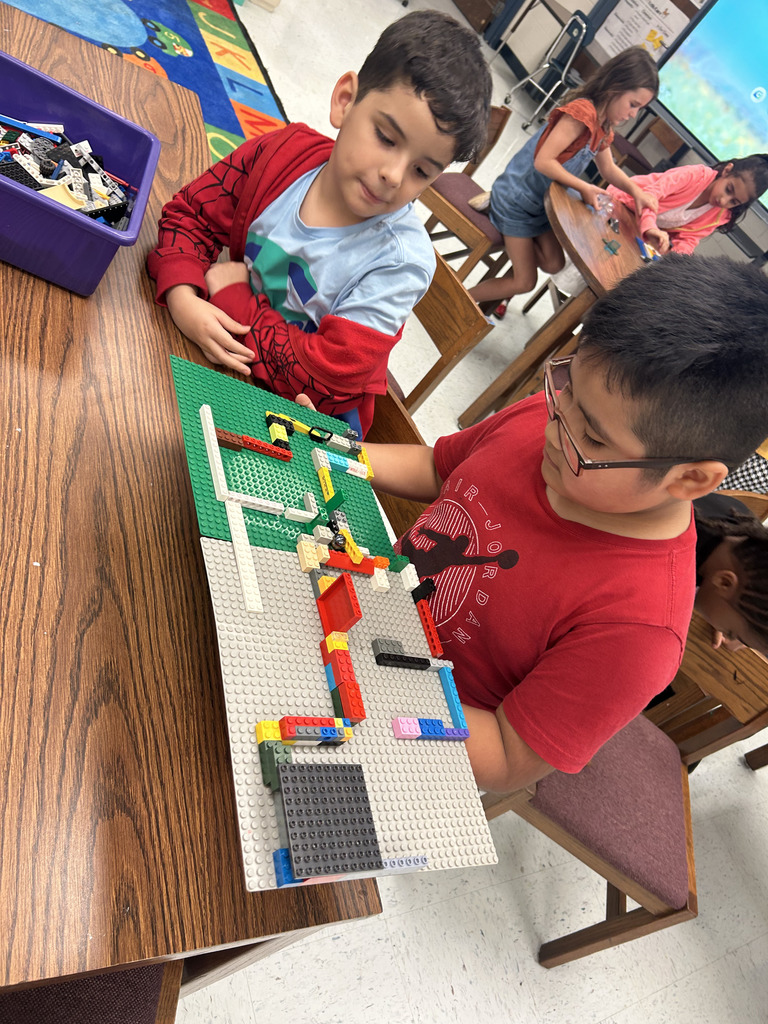 kids working with lego at tables, building mazes