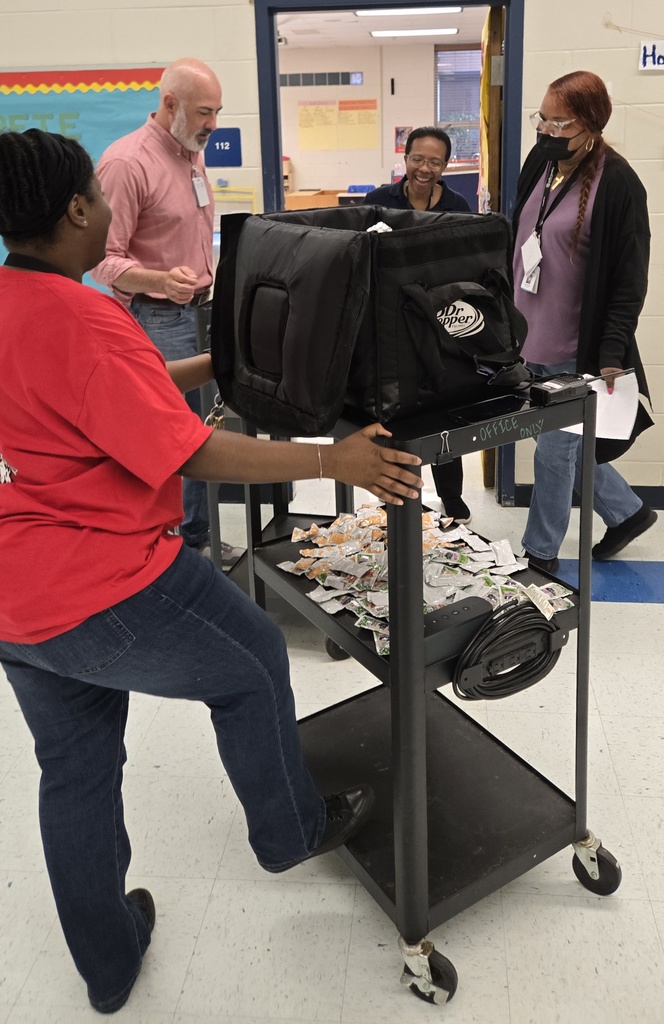 teachers in doors getting biscuits from cart