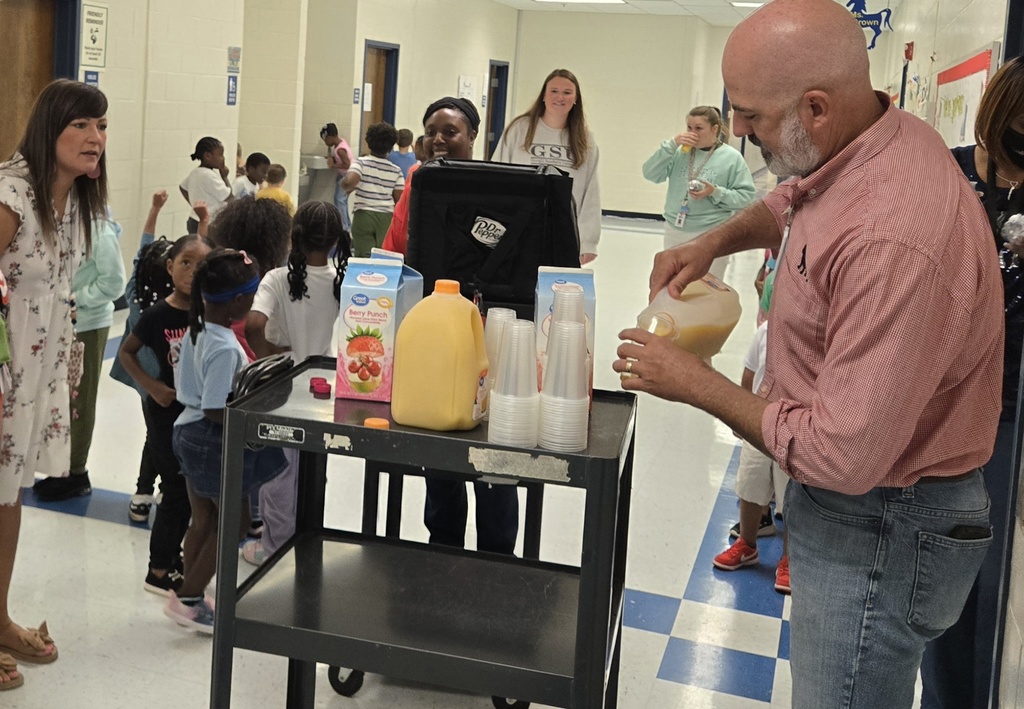 several teachers receiving juice from carts