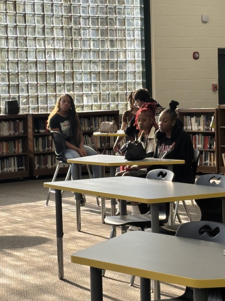 Students listen to presentation during writing workshop