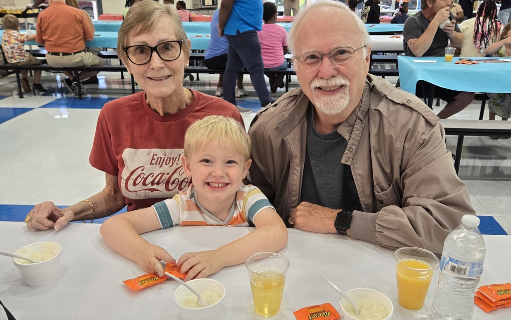 man, woman, and boy at table