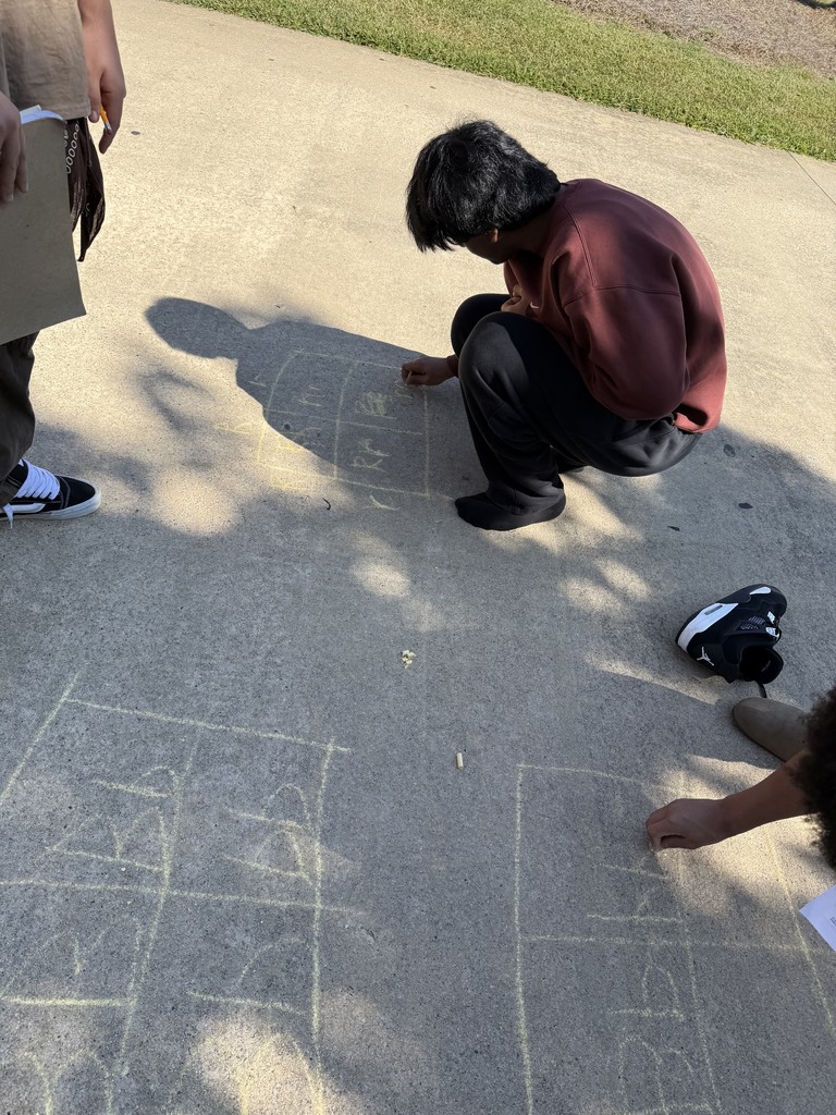 A student puts the finishing touches on one of her Punnett Squares