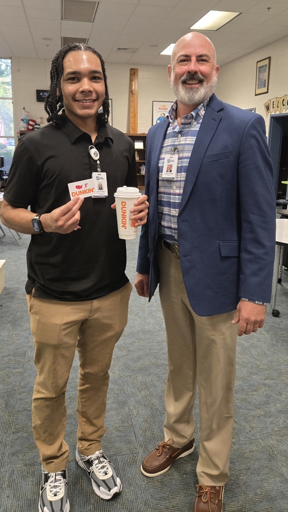 two men standing in the media center
