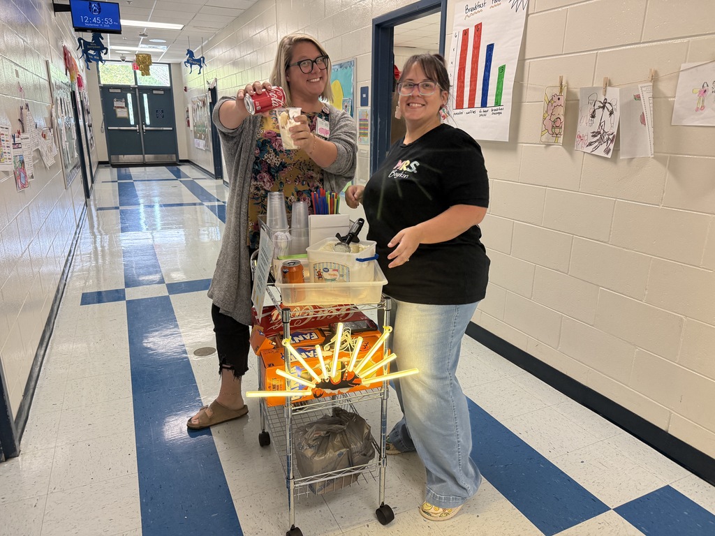 two women at cart with led sunshine, pouring coke floats