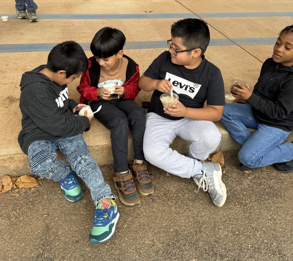 group of kids outside on sidewalk, eating coke floats