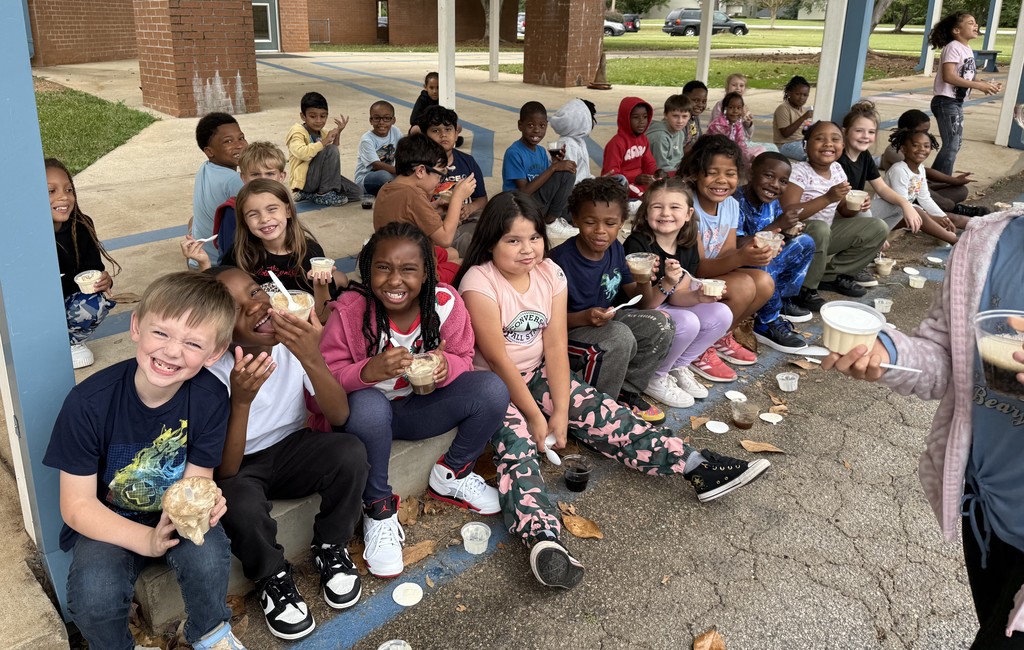 group of kids outside on sidewalk, eating coke floats