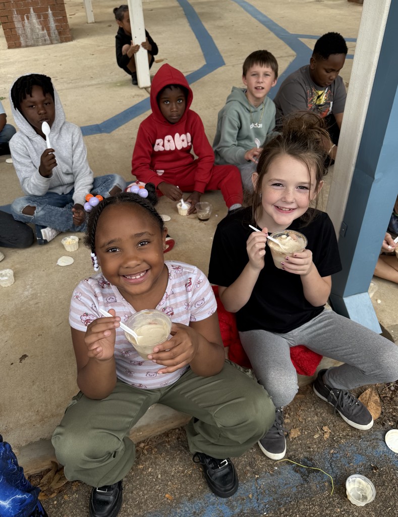 group of kids outside on sidewalk, eating coke floats