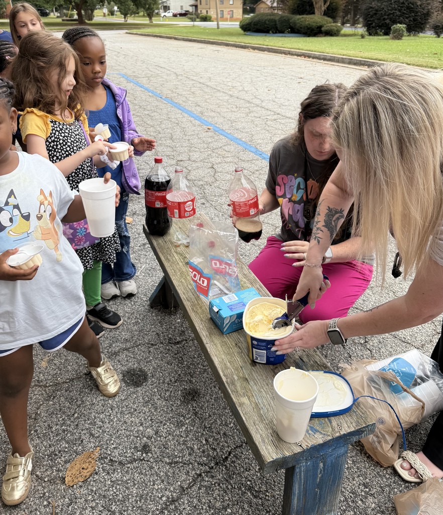 group of kids outside on sidewalk, eating coke floats