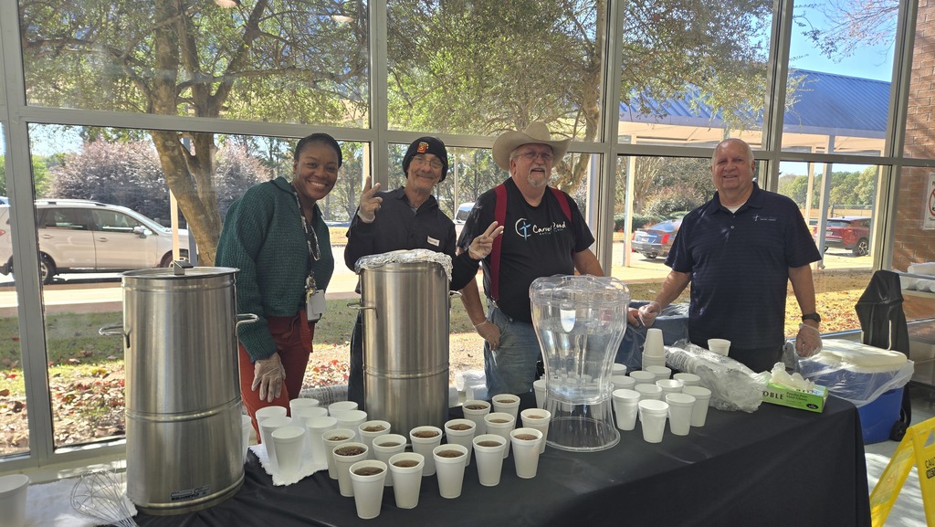volunteers and teacher at drink table with sweet tea and lemonade