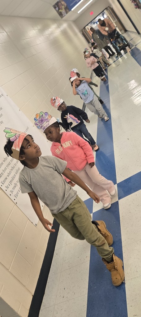 students walking down hall with turkey headbands