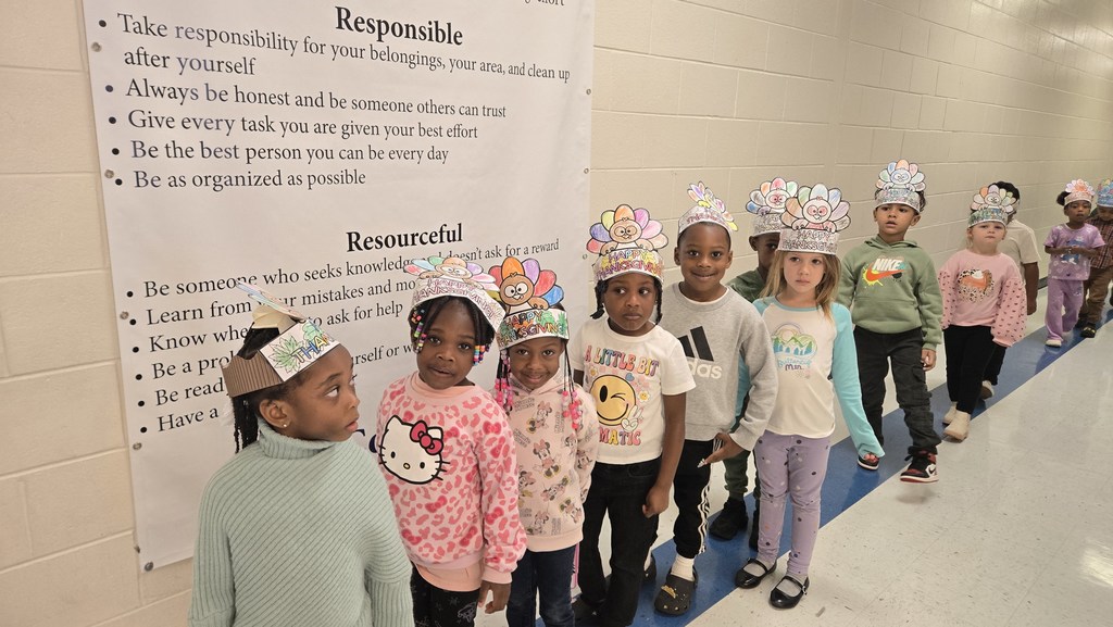 students lined up in hall with headbands