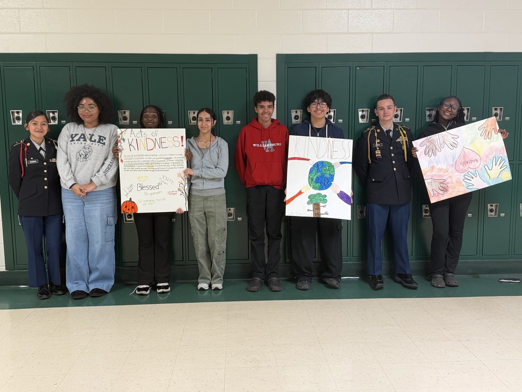 Students hold up their kindness posters