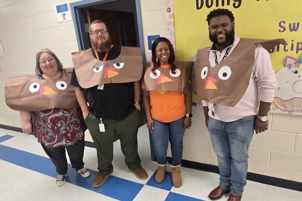 group of four adults with turkey outfits 