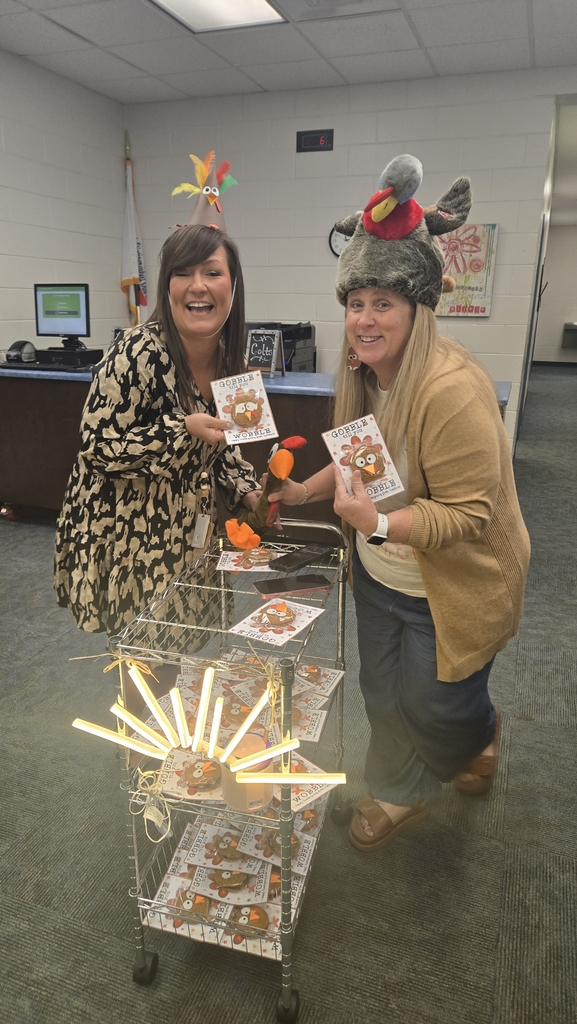 2 women at cart with led sunshine on cart, treats on cart
