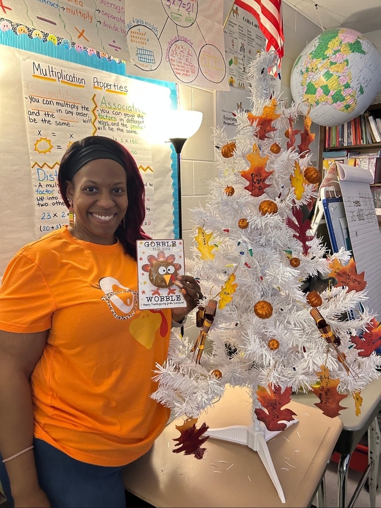 woman by fall decorated tree with turkey