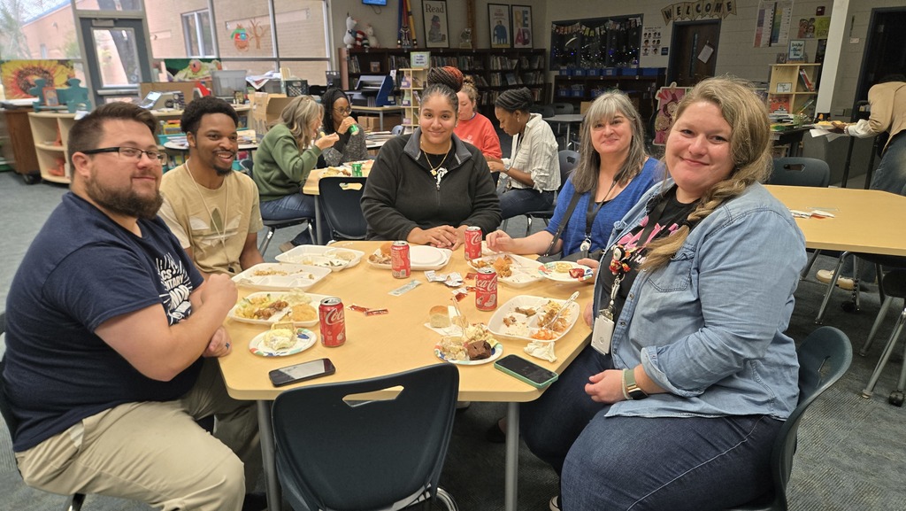 table with adults sitting and eating