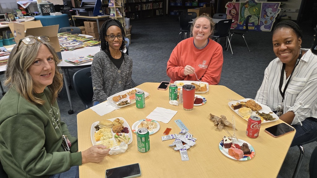 table with adults sitting and eating