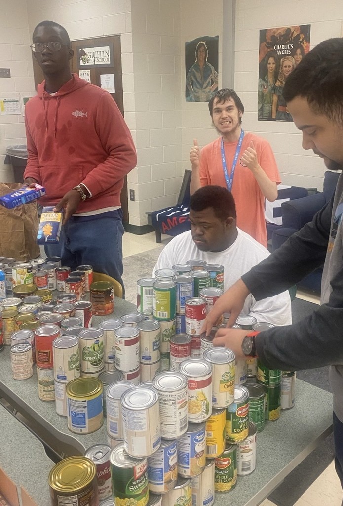 Students help prepare the boxes of canned food