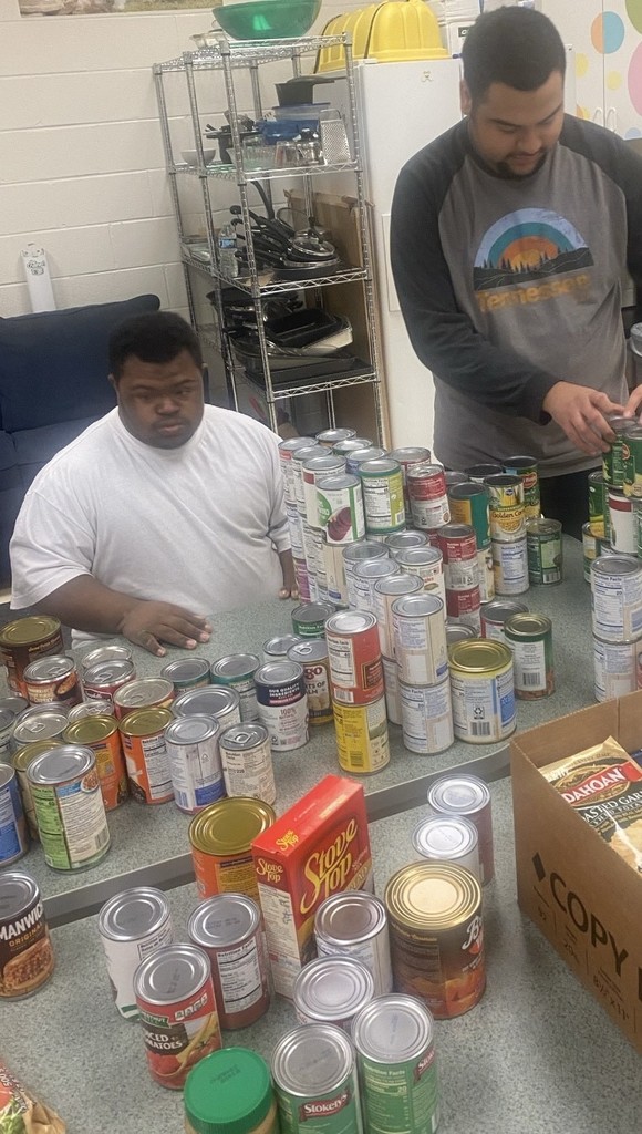 Students separate food into boxes for distribution