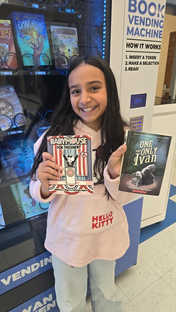 girl in front of vending machine with 2 books