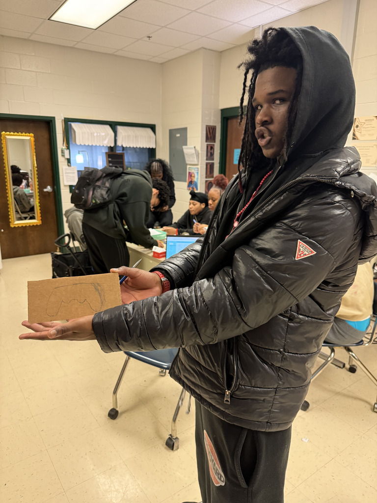 A student proudly shows design