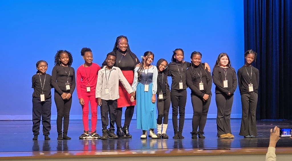 group of students and teacher on stage
